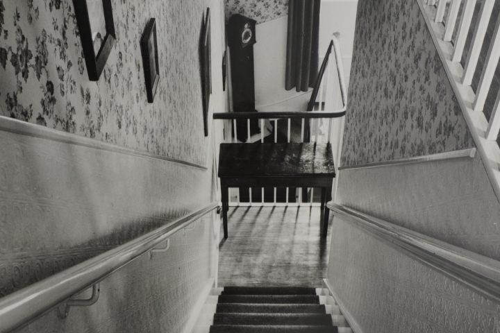 Image looking down stairs in a townhouse.