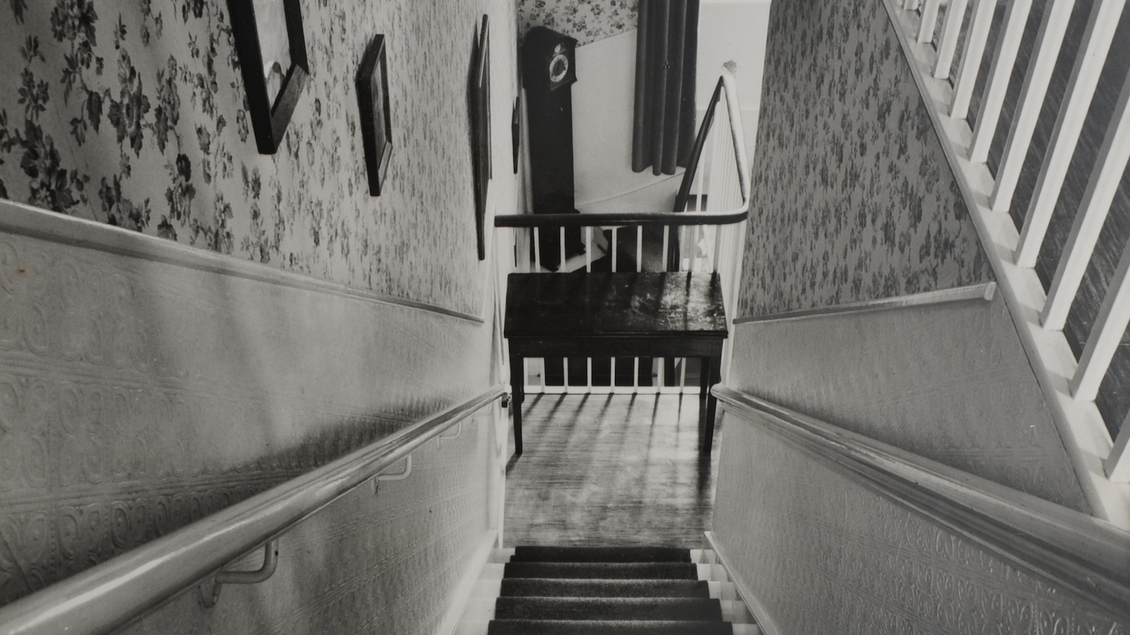 Image looking down stairs in a townhouse.